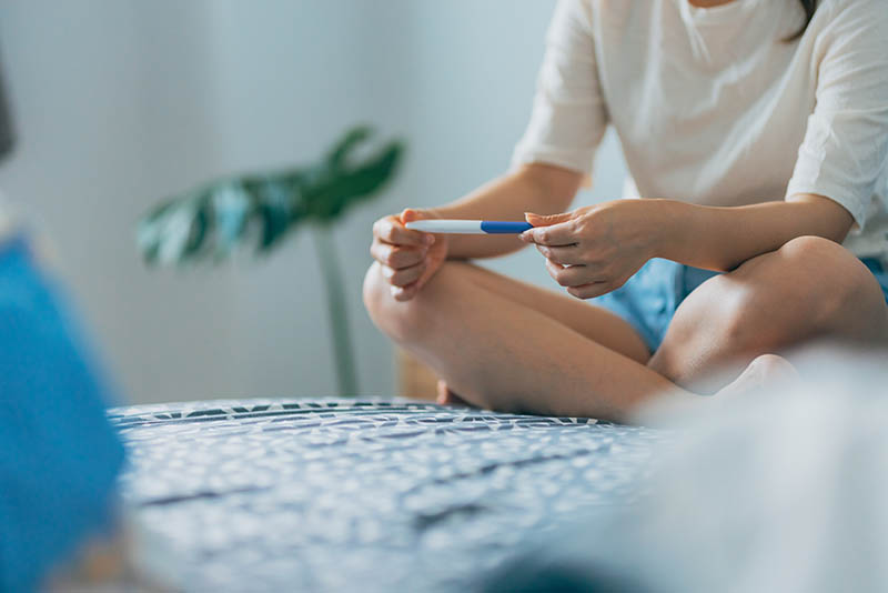 Young woman checking a pregnancy test